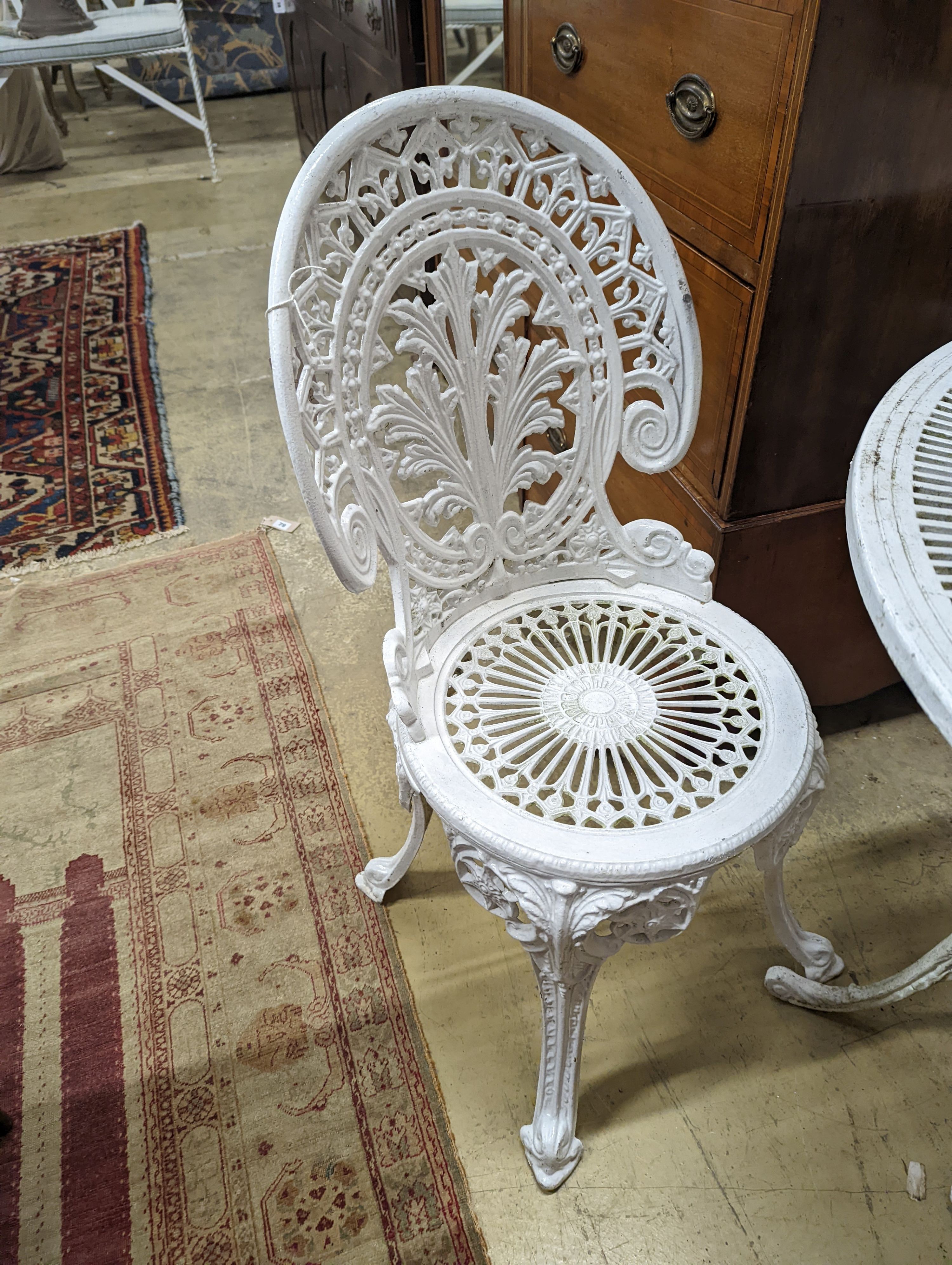 A Victorian style painted aluminium circular garden table, diameter 80cm, height 70cm and four chairs